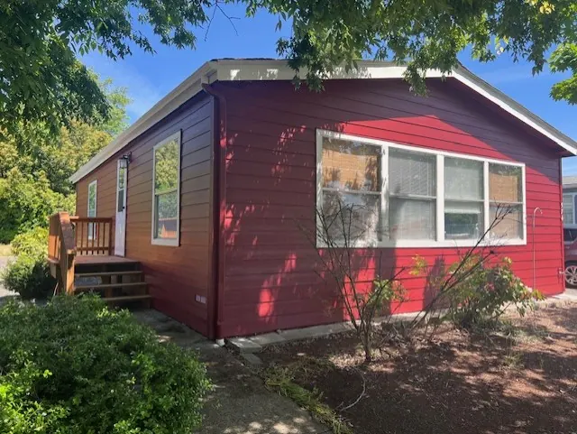 Deep red home with white-trimmed windows